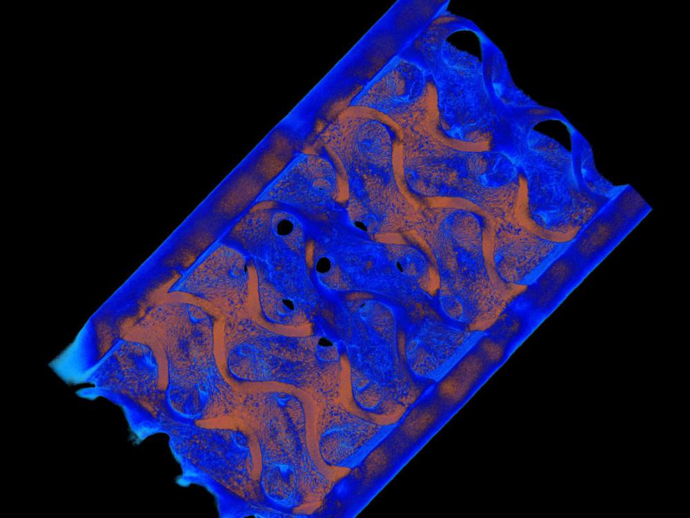 A blue and gold CT scan of a metal beam.
