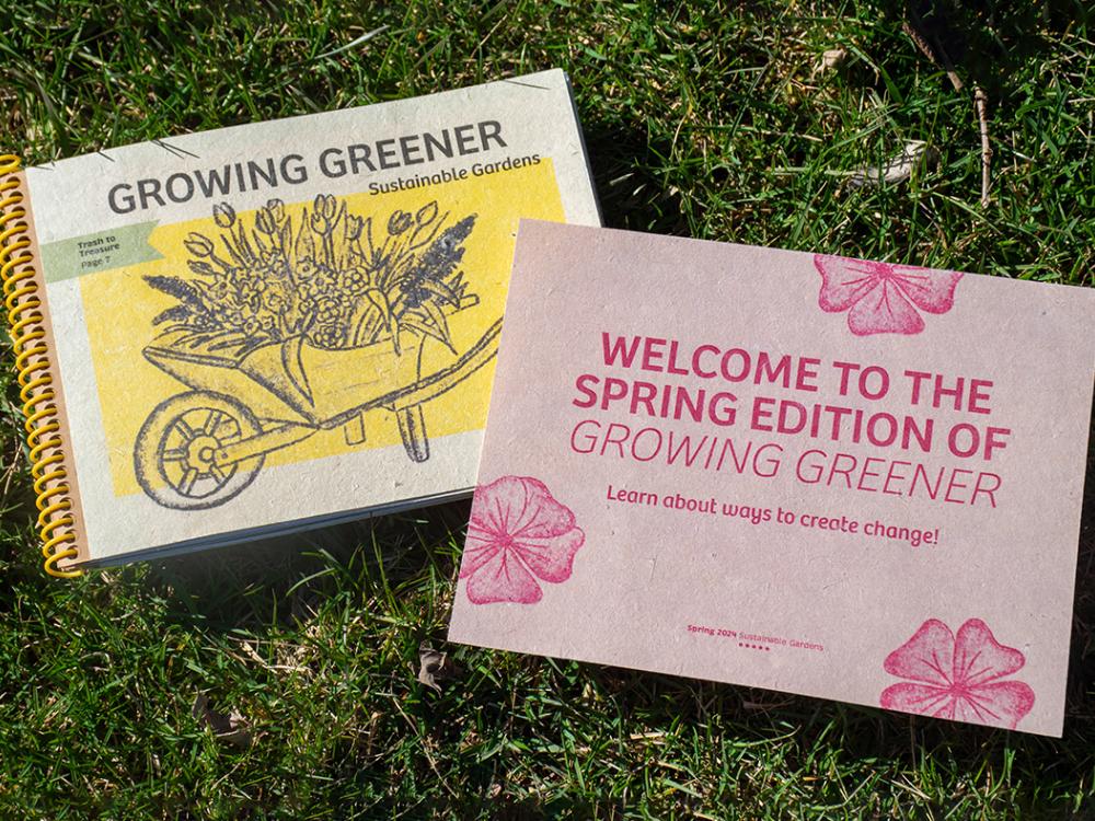 A publication called "Growing Greener" and a flyer promoting the publication atop grass.
