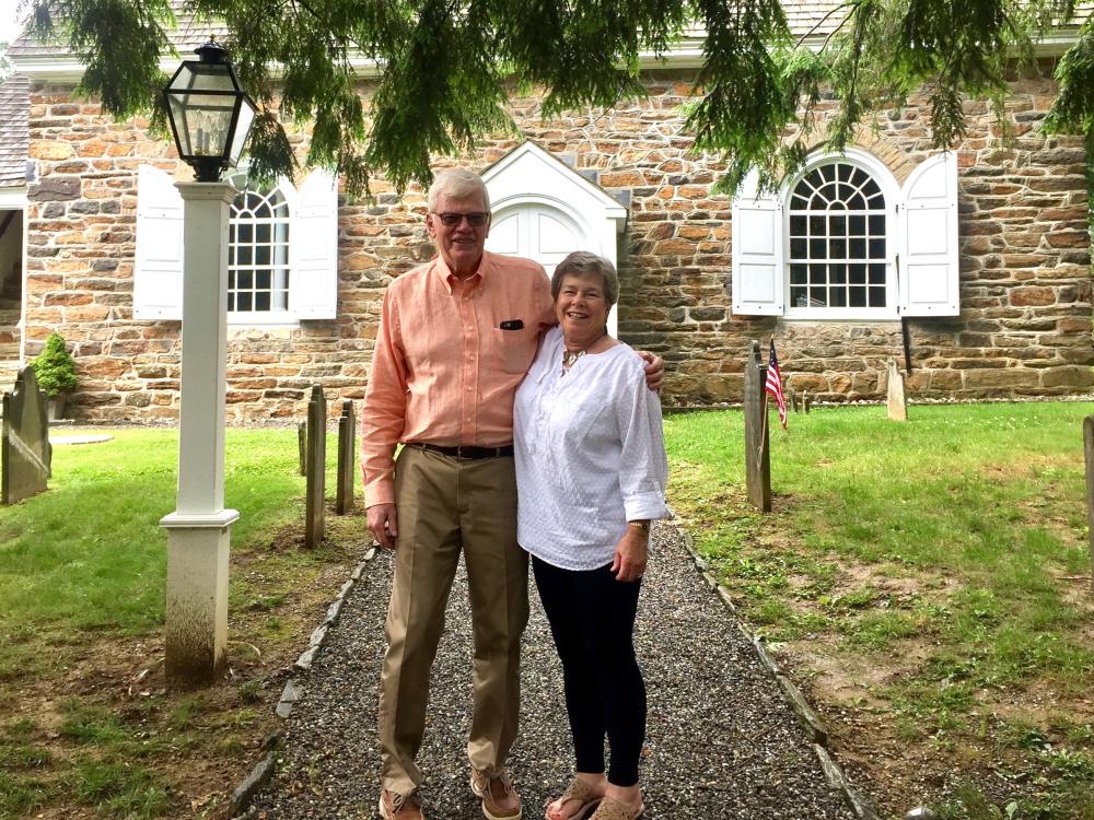 William and Wendy Corb stand near headstones at a historic site.