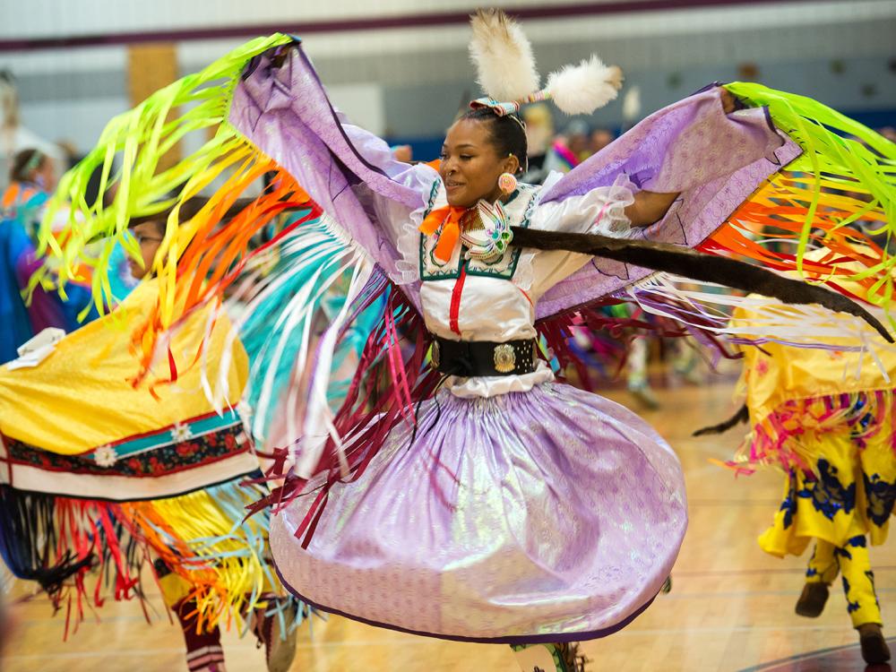 Native American woman dancing in colorful attire