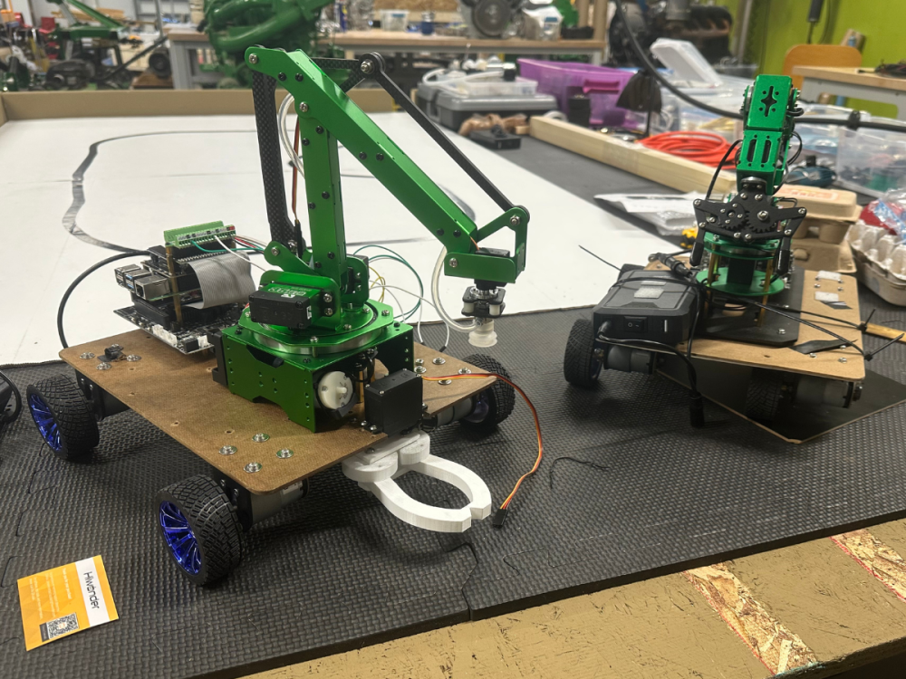 Two green robots resting on a tabletop
